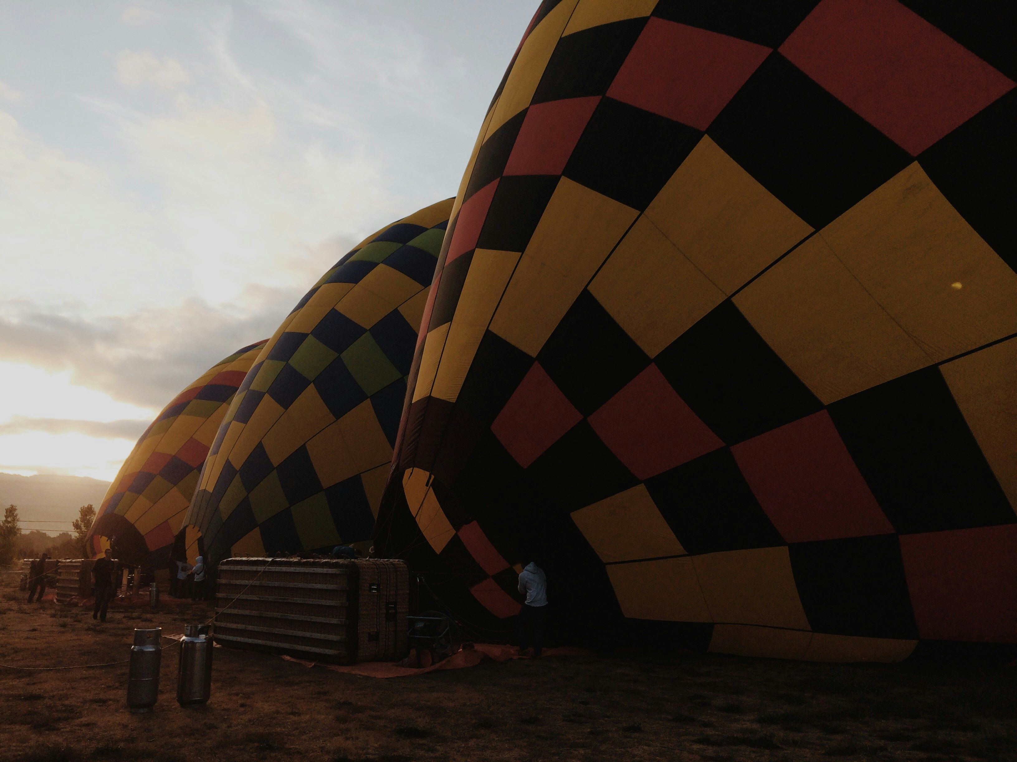 three inflated multicolored hot air balloons on the field